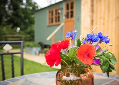 Morndyke Shepherds Huts Exterior with Vase of Flowers